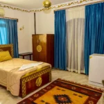 Cozy single room with comfortable bed and traditional wooden wardrobe in Luxor
