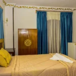 Cozy single room with comfortable bed and traditional wooden wardrobe in Luxor