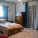 Cozy single room with comfortable bed and traditional wooden wardrobe in Luxor