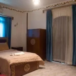Cozy single room with comfortable bed and traditional wooden wardrobe in Luxor