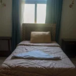 Cozy single room with comfortable bed and traditional wooden wardrobe in Luxor