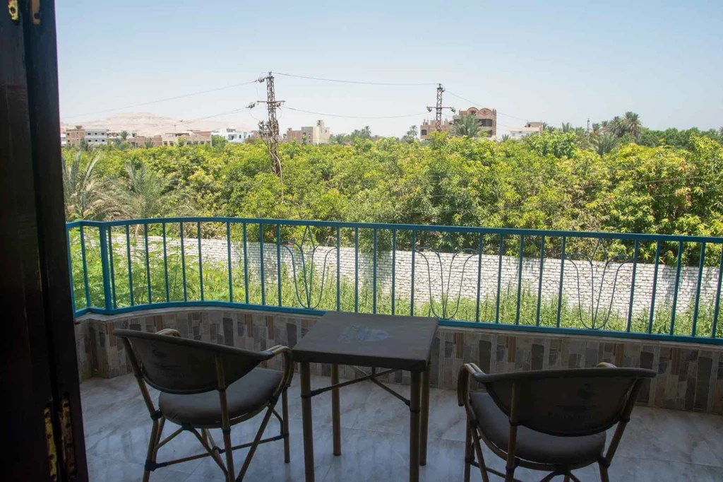 Single room balcony view overlooking greenery in Luxor hotel