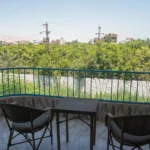 Single room balcony view overlooking greenery in Luxor hotel